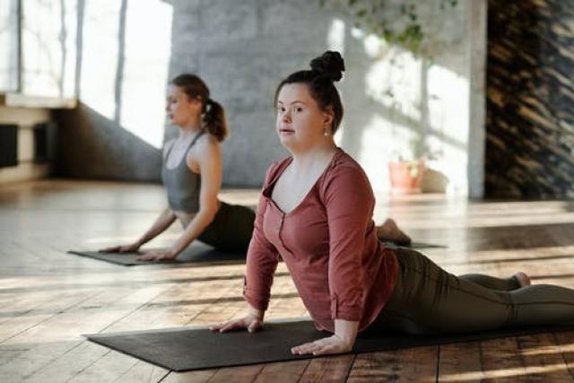 Woman with Downs syndrome doing yoga