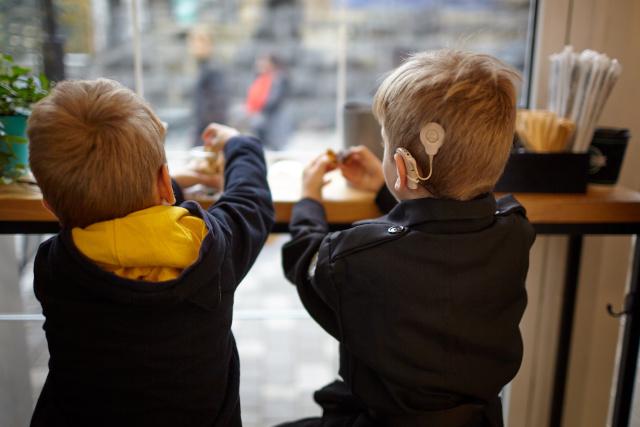 Two boys sat at a counter