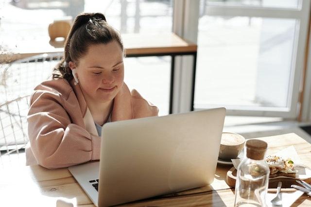 Girl with Downs Syndrome using a laptop